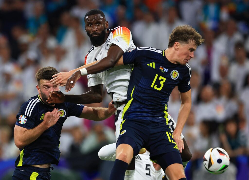 Munich (Germany), 14/06/2024.- Antonio Ruediger (C) of Germany in action against Jack Hendry (R) of Scotland during the UEFA EURO 2024 group A match between Germany and Scotland in Munich, Germany, 14 June 2024. (Alemania-Escocia) EFE/EPA/MARTIN DIVISEK