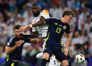 Munich (Germany), 14/06/2024.- Antonio Ruediger (C) of Germany in action against Jack Hendry (R) of Scotland during the UEFA EURO 2024 group A match between Germany and Scotland in Munich, Germany, 14 June 2024. (Alemania-Escocia) EFE/EPA/MARTIN DIVISEK